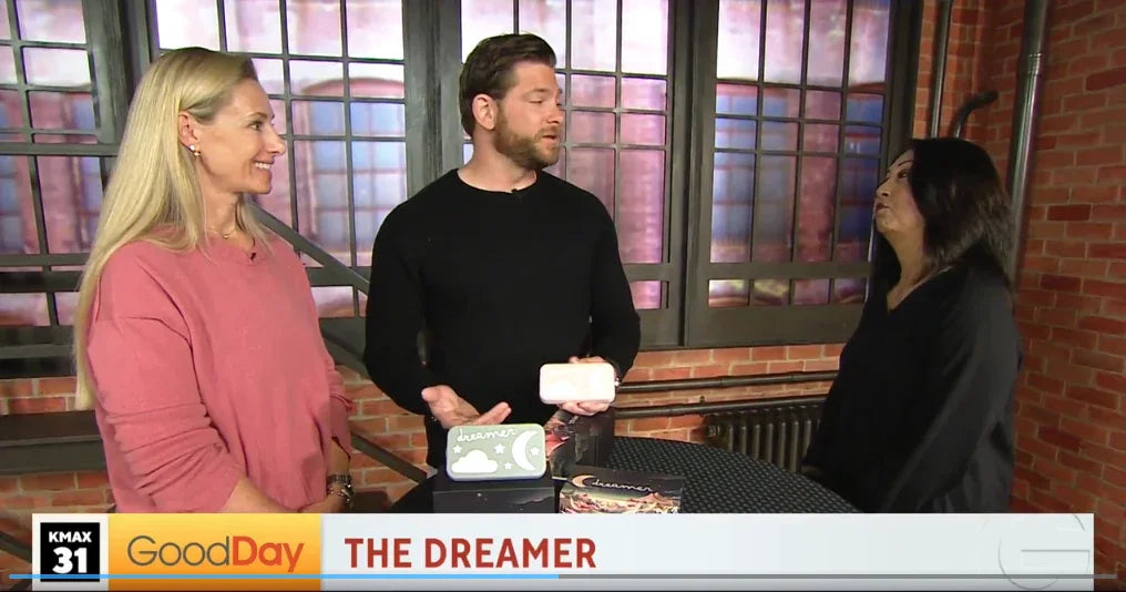 Three people discussing a baby sound machine product called Dreamer on a TV morning show.
