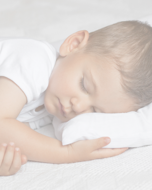 Sleeping baby on white pillow, calm sleep environment, peaceful bedtime scene
