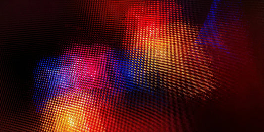 Abstract close-up of colorful light dots with vivid red, blue, and yellow hues on a textured surface