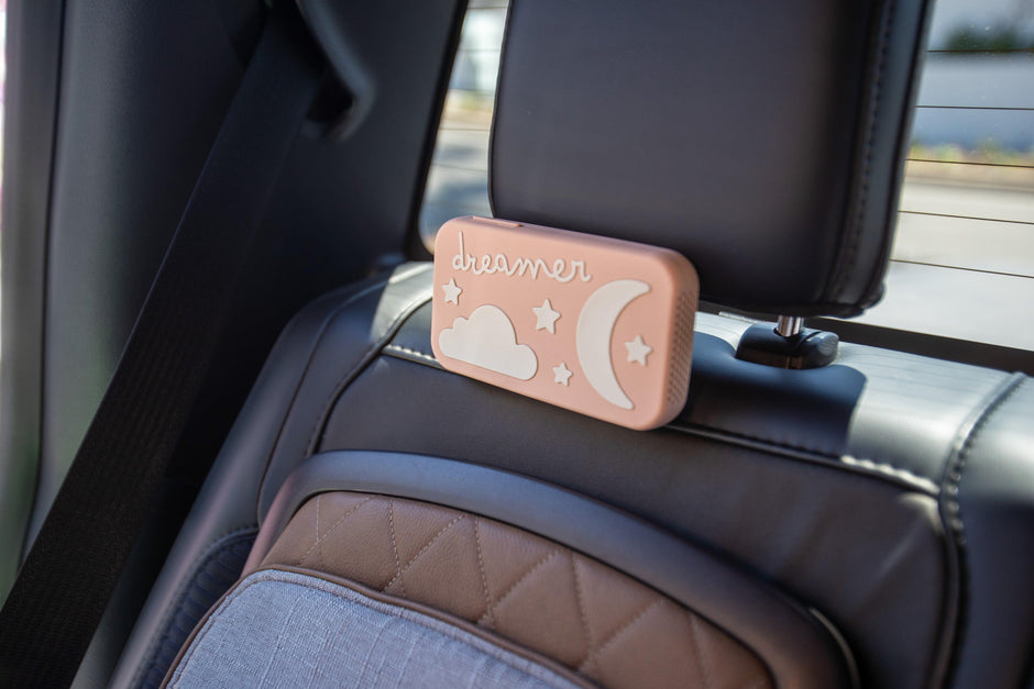Dreamer baby sound machine attached to car headrest (Peach-Dreamer)