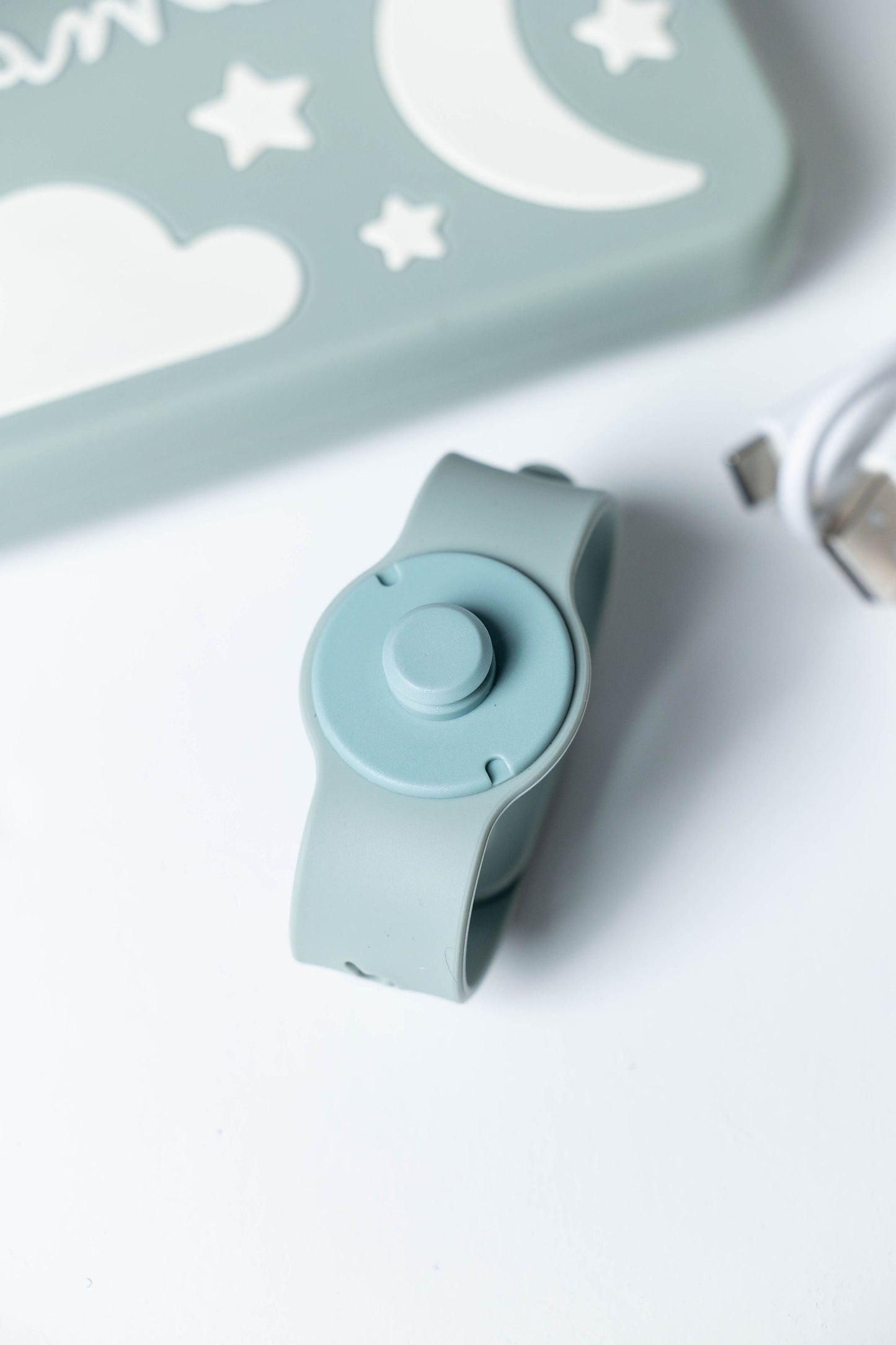 Dreamer™ baby sound machine in sage green silicone with case and USB-C charging cable