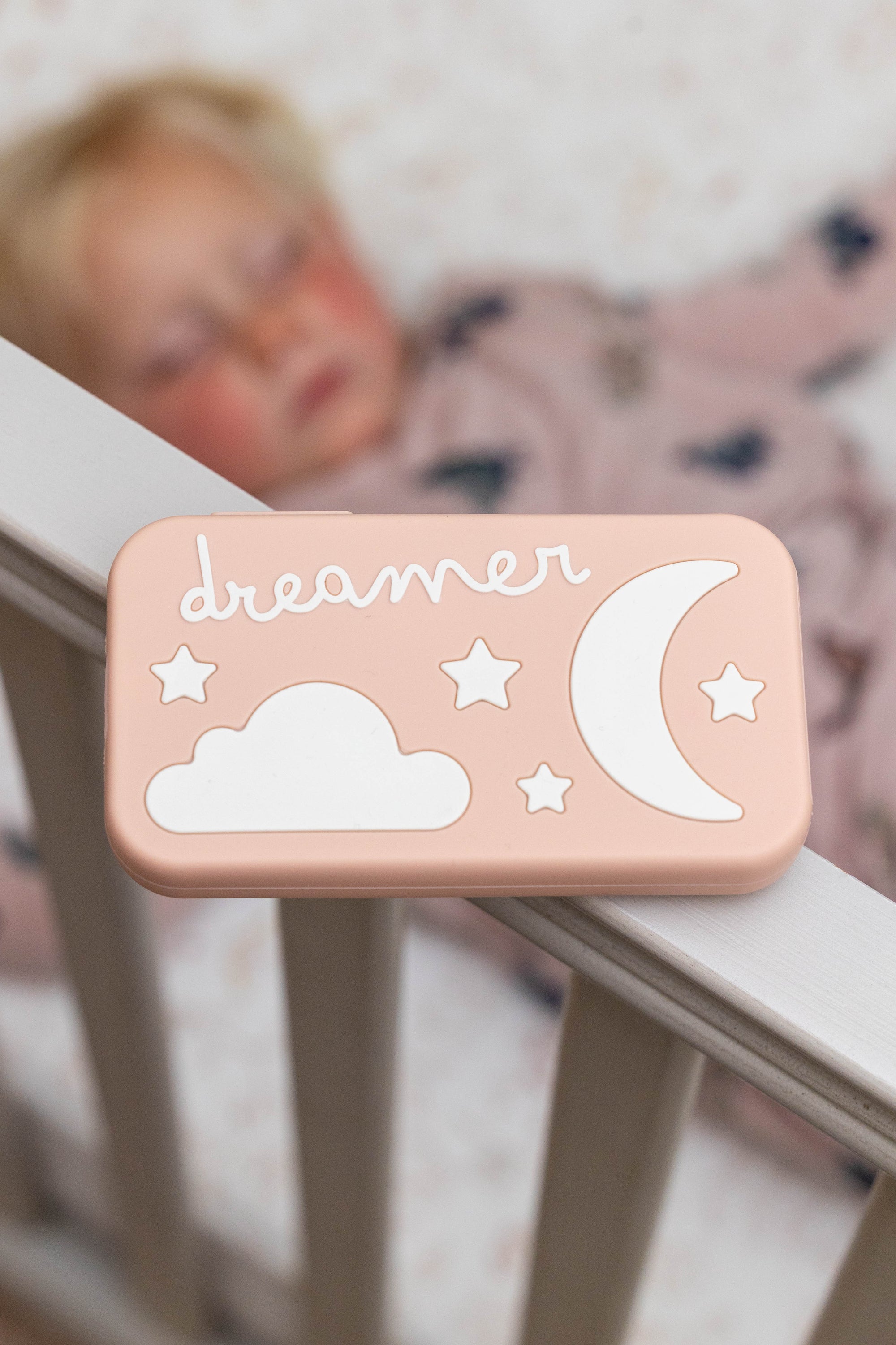 Peach Dreamer in a crib setting